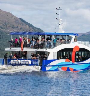 a ferry boat filled with people on the water