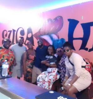 a group of people posing in front of a wall