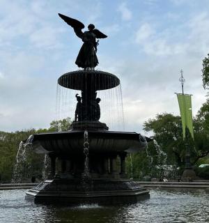 a statue of an angel sitting on top of a fountain