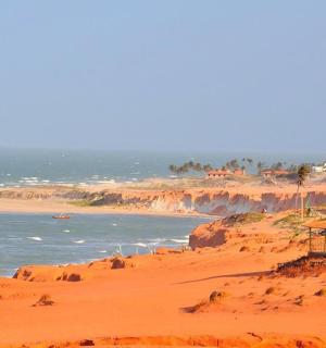 a beach with a house and the ocean