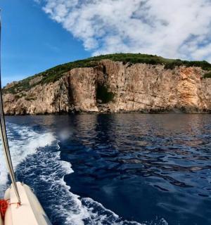 a boat in the water with an island in the background