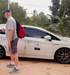 a man and a woman standing next to a white car