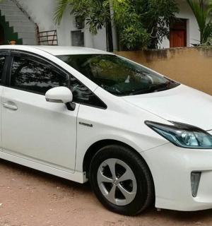 a white car parked in front of a house