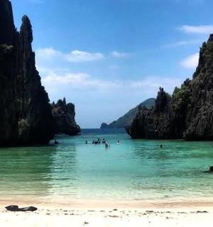 a group of people in the water at a beach