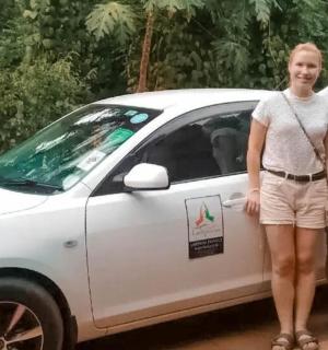 two people standing in front of a white car