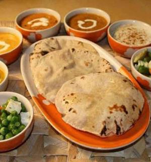 a table with a plate of food and bowls of food