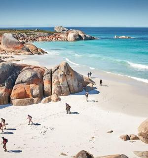 a group of people on a beach near the ocean