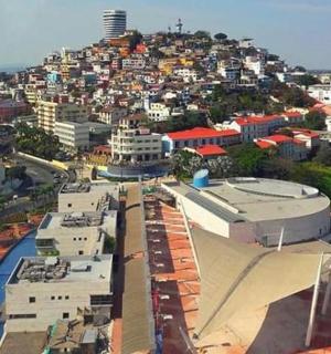 an aerial view of a city with a hill