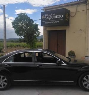 a black car parked in front of a building