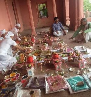 a group of people sitting around a table filled with figurines