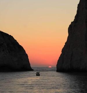 a group of people in the water between two large rocks