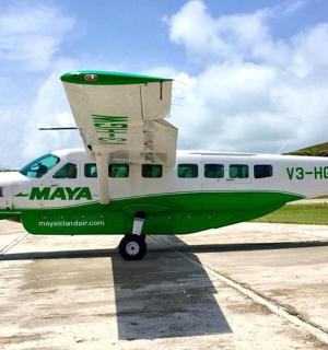 a small green and white plane sitting on a runway
