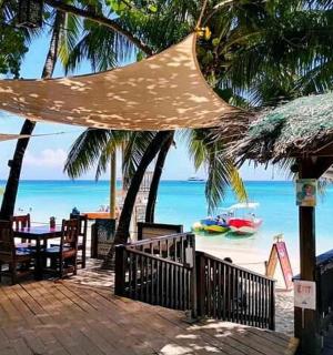 a beach with a tent and chairs and the ocean