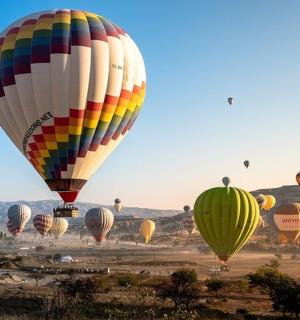 a bunch of hot air balloons flying in the sky