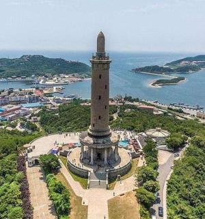 an aerial view of a clock tower in front of the water