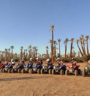 a group of people riding on quad bikes and atvs