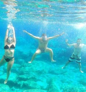 three people swimming in the water in the ocean