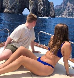 a man and a woman sitting on a boat in the water