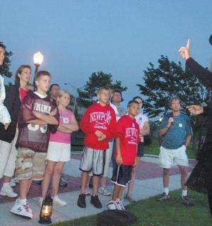 a woman standing in front of a group of people