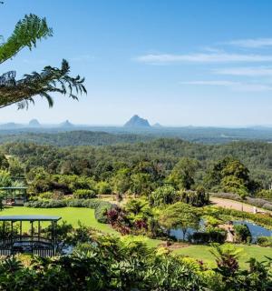 a view of a park with a picnic table and trees