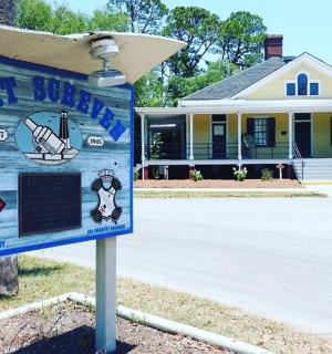 a sign in front of a house