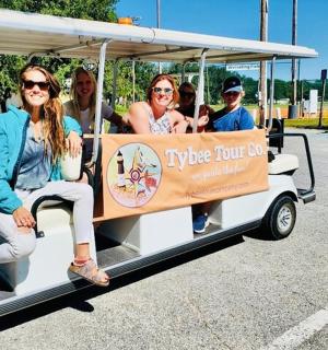 a group of people riding in a golf cart