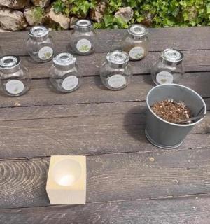 a group of jars and a bucket on a wooden bench