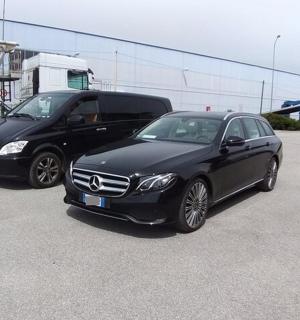 two cars parked next to each other in a parking lot