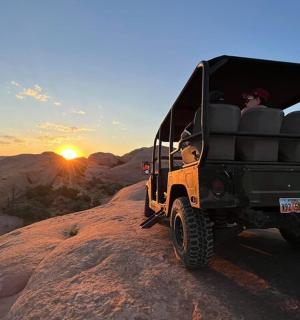 a jeep driving down a dirt road in the desert