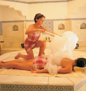 a woman is standing over a woman laying on the floor