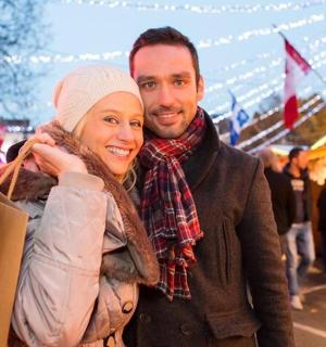 a man and woman posing for a picture at a market