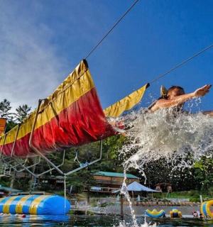a man jumping into the water at a water park