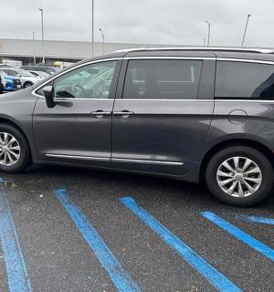 a silver van parked in a parking lot