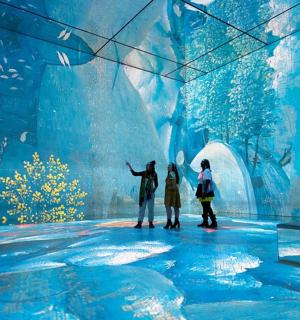 a group of people standing in front of a large aquarium
