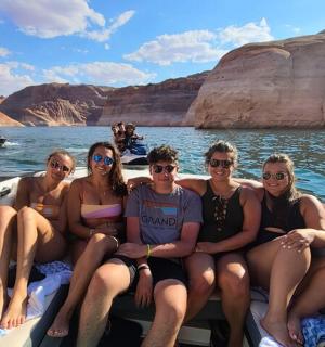 a group of people sitting on a boat in the water