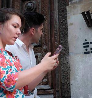 a man and a woman looking at a cell phone