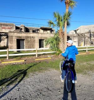 a person riding a bike in front of a building