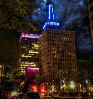 a building with a neon sign on top of it at night