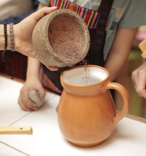 桌子上拿着帽子和水壶的人