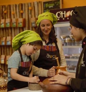 a woman and three children in a store preparing food