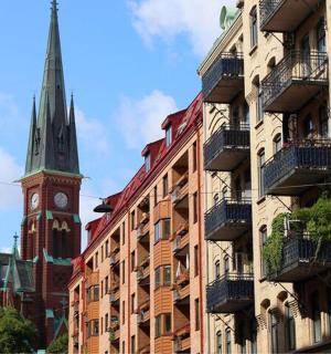 a group of buildings with a clock tower and a church