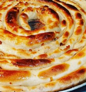 a close up of a cheese pizza in a pan