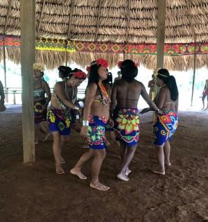 a group of women in bathing suits on a beach
