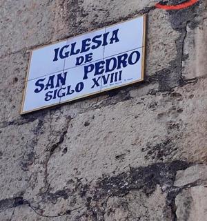 a sign on the side of a brick wall