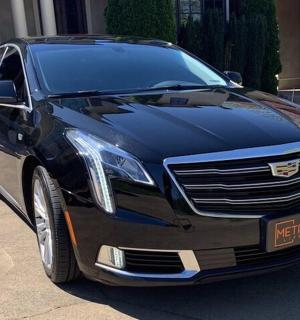 a black car parked in front of a building
