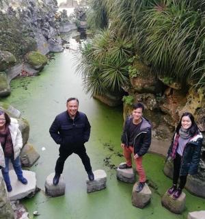 a group of people standing on rocks in a river