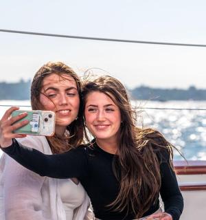 a man and a woman taking a picture on a boat