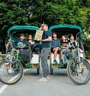 a group of people in a golf cart with a bike