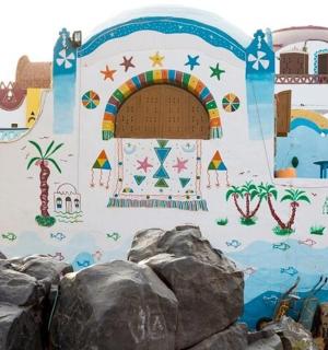 a mural on the side of a building with a rainbow