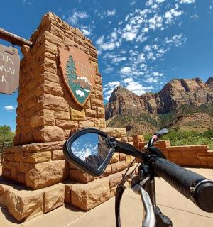 a mirror of a bike parked next to a sign